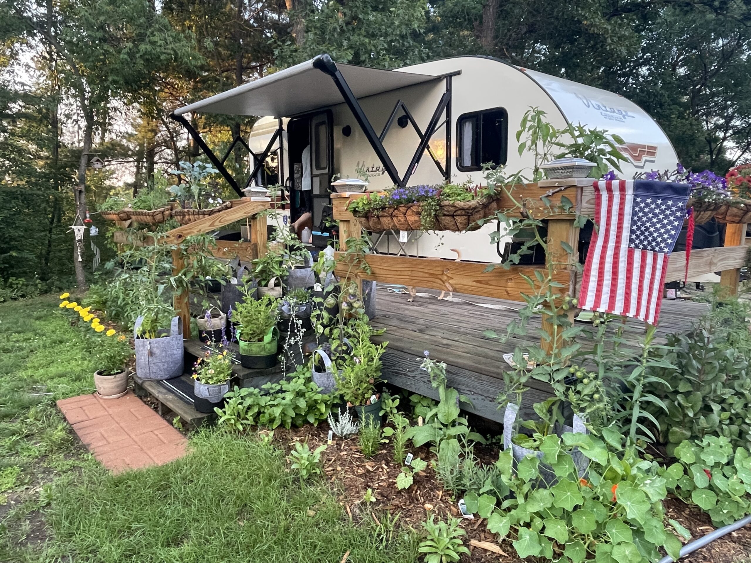 A camper RV with a huge garden around it